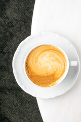 Swirling latte art in gleaming cup, cozy caffeine ritual, Hygge harmony, International Coffee Day celebration, invigorating warmth