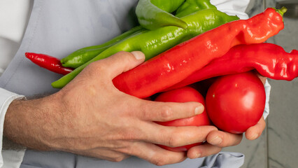 A Caucasian male chef cradles vibrant peppers and tomatoes, evoking La Tomatina spirit and...