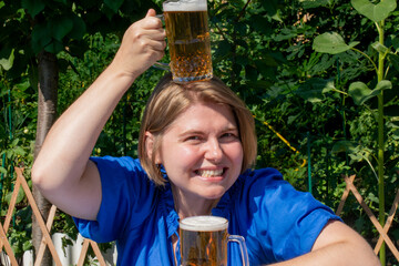 Cheerful Caucasian woman balancing beer steins, reveling in Oktoberfest exuberance, toasting to...