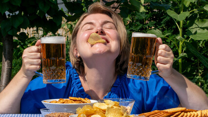A jubilant Caucasian woman revels in Oktoberfest joy, balancing chips on her nose, holding frothy...