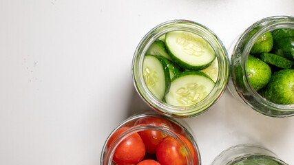 Pickling jars brim with vibrant cucumbers and tomatoes, celebrating fermentation's magic on...