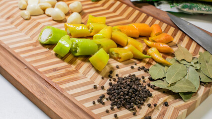 Zesty peppers mingle with garlic and bay leaves on a geometric board, evoking salsa fiestas and...