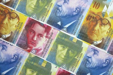 Swiss franc banknotes. The current francs money bills lies on table in big amount close up