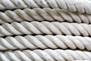 Intricate details of stacked white ropes, highlighting their texture and patterns