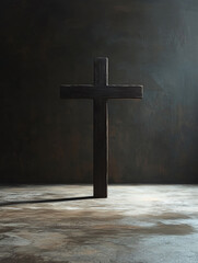Naklejka premium Wooden cross casting shadow on textured surface in dim light.