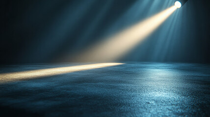 Spotlight beam illuminating dark empty stage floor.