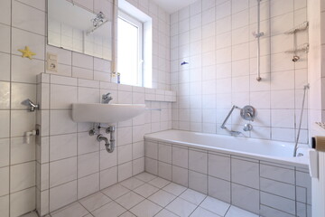 Bathroom with a white sink and a white bathtub