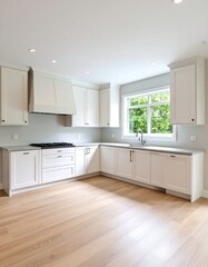 Bright, airy kitchen with white cabinets, light wood floors, and a window overlooking greenery