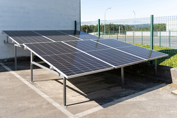 Solar panels installed near a building, harnessing sunlight to generate clean and renewable energy
