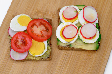 Healthy breakfast, colorful sandwiches top view, on a chopping board