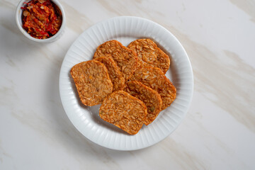 Tempeh, Tempe Goreng or Fried tempeh is Indonesia traditional food, made from fermented soybean seeds. Perfect for recipes, articles or any cooking content.