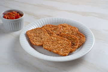 Tempeh, Tempe Goreng or Fried tempeh is Indonesia traditional food, made from fermented soybean seeds. Perfect for recipes, articles or any cooking content.
