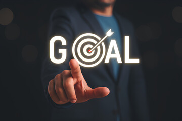 A man points at the word "GOAL" with a target icon replacing the letter "O".