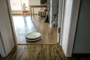 Washing robotic vacuum cleaner device cleaning tile or laminate floor in the room
