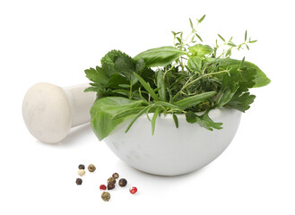 Mortar with different fresh herbs, peppercorns and pestle isolated on white