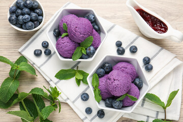 Tasty sorbet with blueberries, mint and jam on wooden table, flat lay