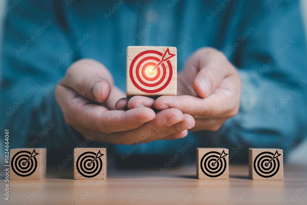 Poster businessman holding up red dartboard with arrow from black for enhance setup business objective targ