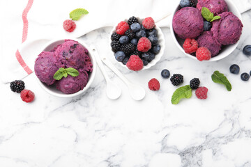 Delicious sorbet with fresh berries and mint on white marble table, flat lay. Space for text