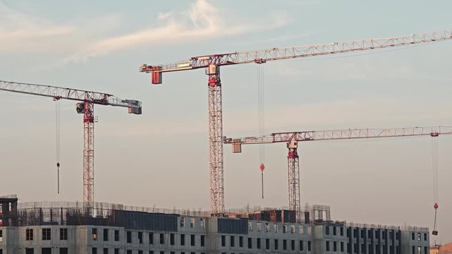 Construction of a large residential area, construction panorama with high construction cranes, construction of monolithic reinforced concrete properties