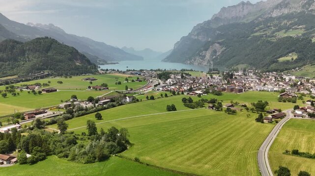 Scenic Aerial View of a Valley with Green Fields and Mountain Landscape in Switzerland near Flums, Berschis, and Walenstadt in the Canton of St. Gallen &ndash; Drone Footage