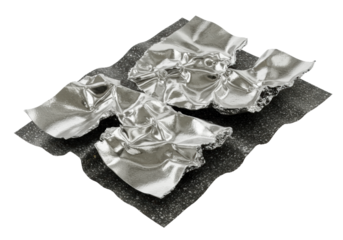 A crumpled, highly reflective silver metallic foil with intricate wrinkles, torn edges revealing a dark, granular texture, high-angle on a transparent background with copy space, no shadows,