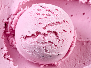 Close-up of a scoop of pink strawberry ice cream. The ice cream is smooth and has a textured...