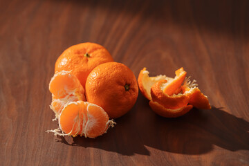 Peeled tangerines on a walnut wood table