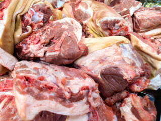 Fresh cuts of meat displayed at a local market in sunny afternoon highlighting local food culture and traditional offerings