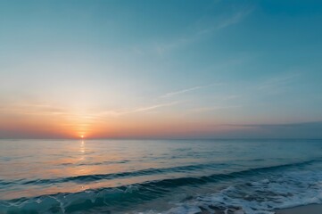 Obraz premium Serene Ocean Sunset with Calm Waves and Clear Sky During Evening