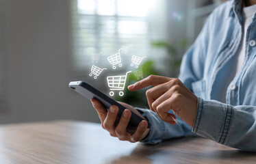 Young woman using smartphone with shopping cart icon.