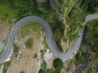 Top down aerial photo of a road twisting round the limestone cliff formations in a double hairpin bend at Cheddar gorge in the Mendip Hills, Somerset, UK