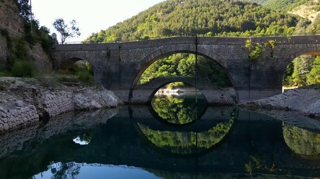 Aerial drone view of Lake San Domenico in the municipality of Villalago in the province of L'Aquila, near the hermitage of San Domenico. Beautiful green hues and peace reign supreme in this place.