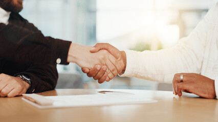 Shaking hands, interview and thanks for hiring at office with resume, documents and contract at company. People, HR manager and staff recruitment with handshake, onboarding and paperwork at agency