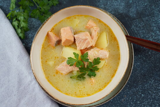 Fish soup in a bowl.Creamy fish soup with salmon, potatoes, onions , carrots, dill and celery. Kalakeitto- traditional dish of the Finnish cuisine or Russian Ukha Fish Head Soup. Healthy Food Concept.