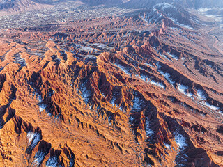A stunning high angle aerial shot reveals the dramatic red and brown terrain of Mars Canyon with...