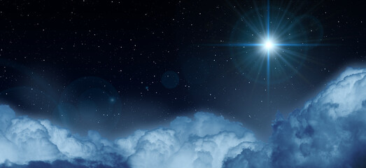 Glowing star in the night starry cloudy sky. Symbol of Christmas and New Year.