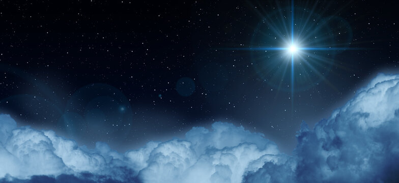 Glowing star in the night starry cloudy sky. Symbol of Christmas and New Year.