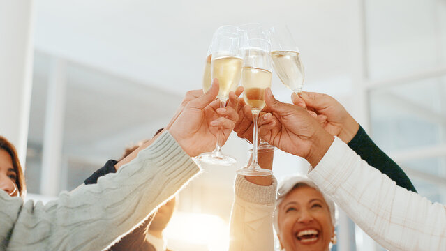 Hands, champagne toast and celebration at office, achievement or low angle for drinks at company. Business people, glass and team with alcohol, success or sparkling wine for profit increase at agency