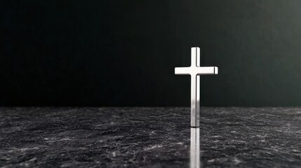 Minimalist Silver Cross Resting on Dark Textured Surface Symbolizing Faith and Contemplation