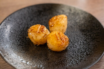 Grilled scallop served on plate