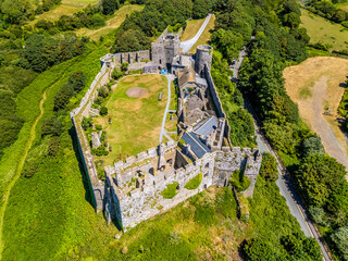 An aerial view above the old Norman castle ruins at the seaside resort of Manorbier, South Wales in...