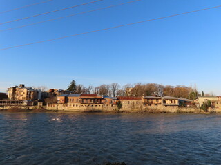 Obraz premium A scenic view of the riverside in Kutaisi, Georgia, featuring the gentle flow of the Rioni River alongside the city's historic charm.