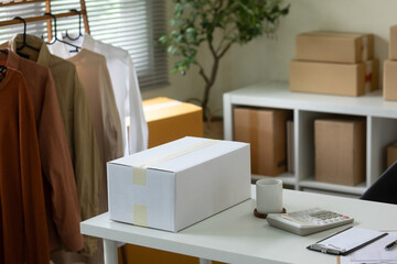A package containing goods sits on a table in a small office.