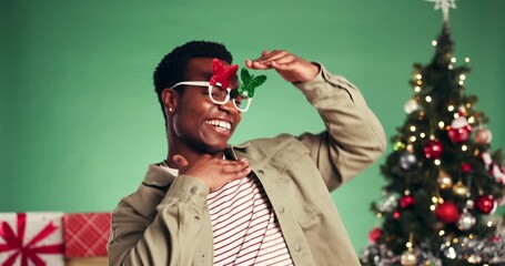 Christmas, frame and man with smile, dancing and excited for celebration, festive season and studio. Green background, face and happy for December holiday, rhythm or black person with xmas sunglasses - Powered by Adobe