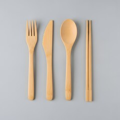Eco-friendly bamboo cutlery set for sustainable dining on a grey background