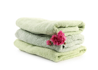 Stack of towels and flowers isolated on white