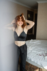 Young woman enjoys playful moment in stylish indoor setting