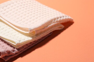 Clean waffle towels on coral background, closeup