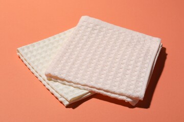 Clean waffle towels on coral background, closeup