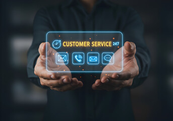 Man holding a glowing customer service interface with 24/7 support icons. Conceptual image for online assistance and communication.